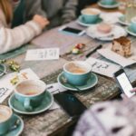 People enjoying coffee around a table