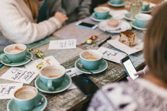 People enjoying coffee around a table