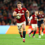 The British & Irish Lions’ Huw Jones runs with the ball during the 2025 match against Queensland Reds.